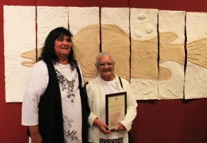 Two of the Euraba artists with their winning work, "Gaduu - Murray Cod"; a mixed medium work using plant fibres and rag paper
